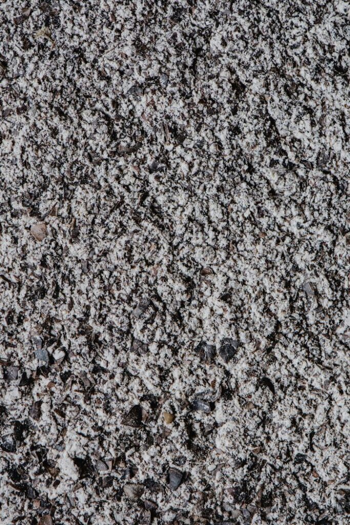 Detailed close-up texture of rough concrete surface for backgrounds.